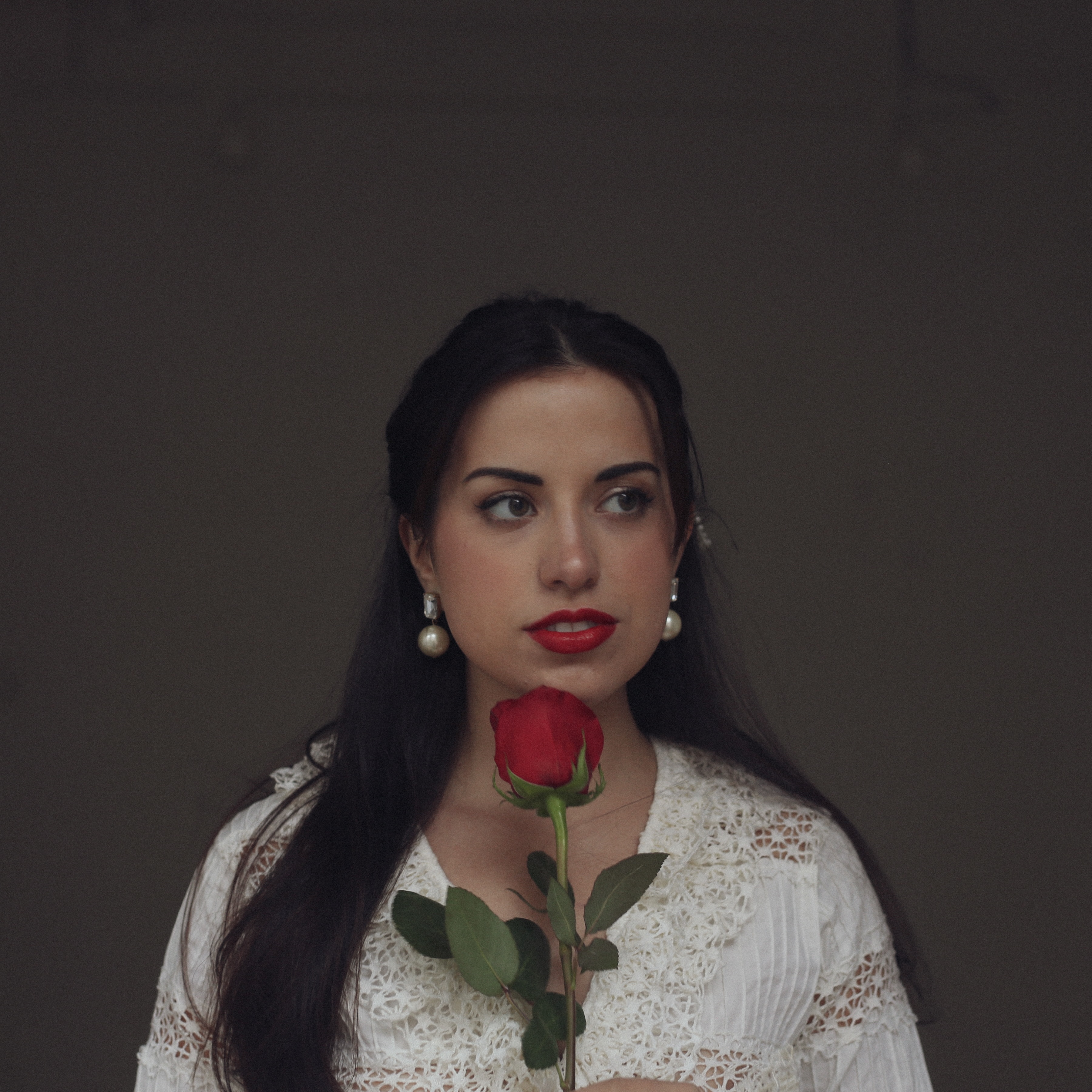 Portrait of Mags Duval holding a red rose