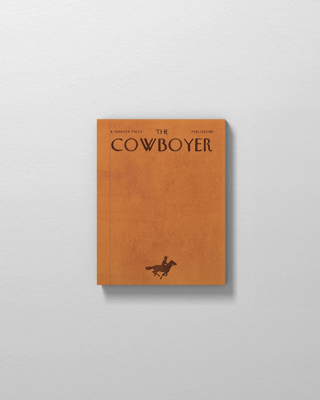 The Cowboyer orange cover with small horseback rider