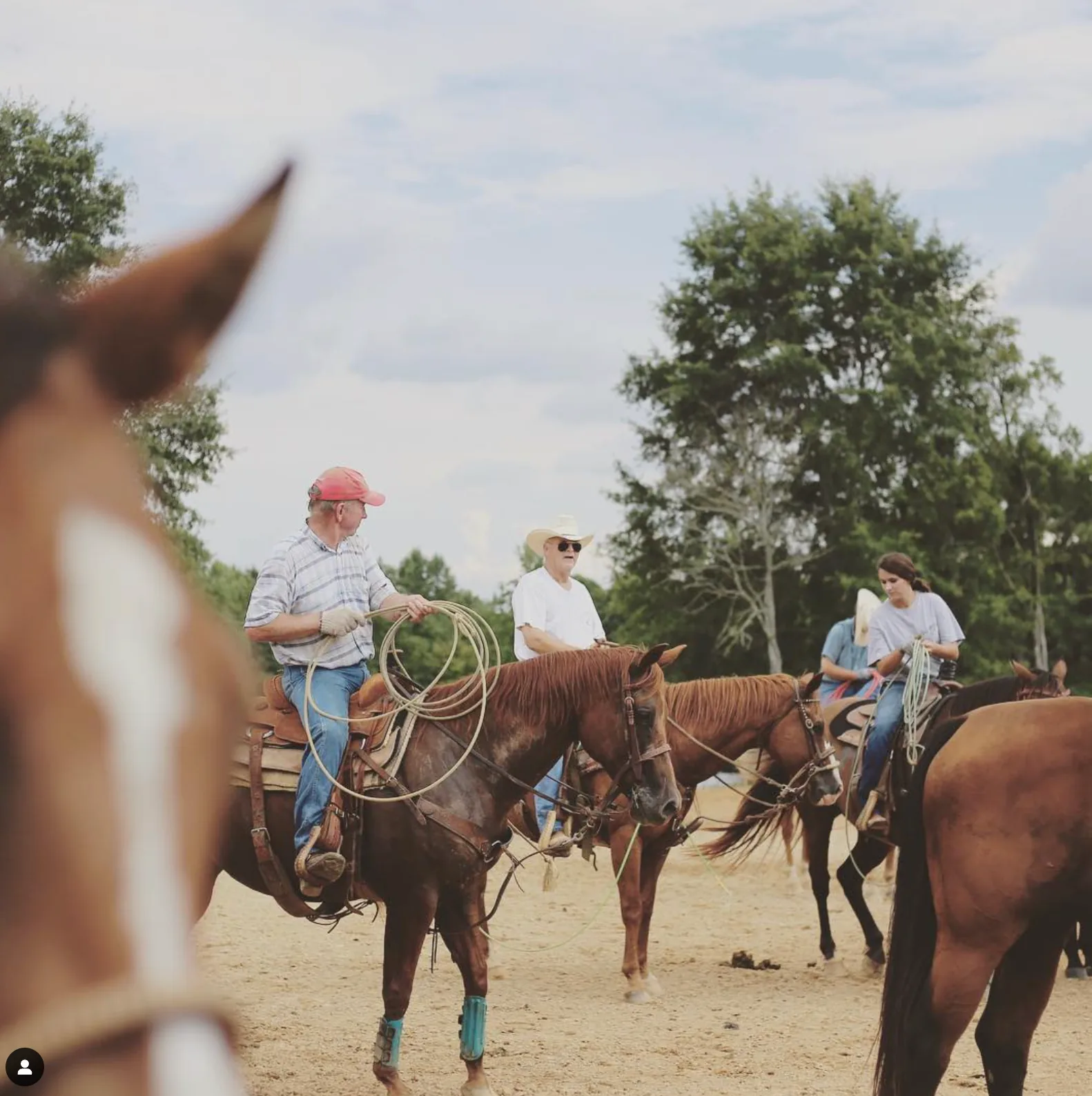 Riders holding ropes on horseback